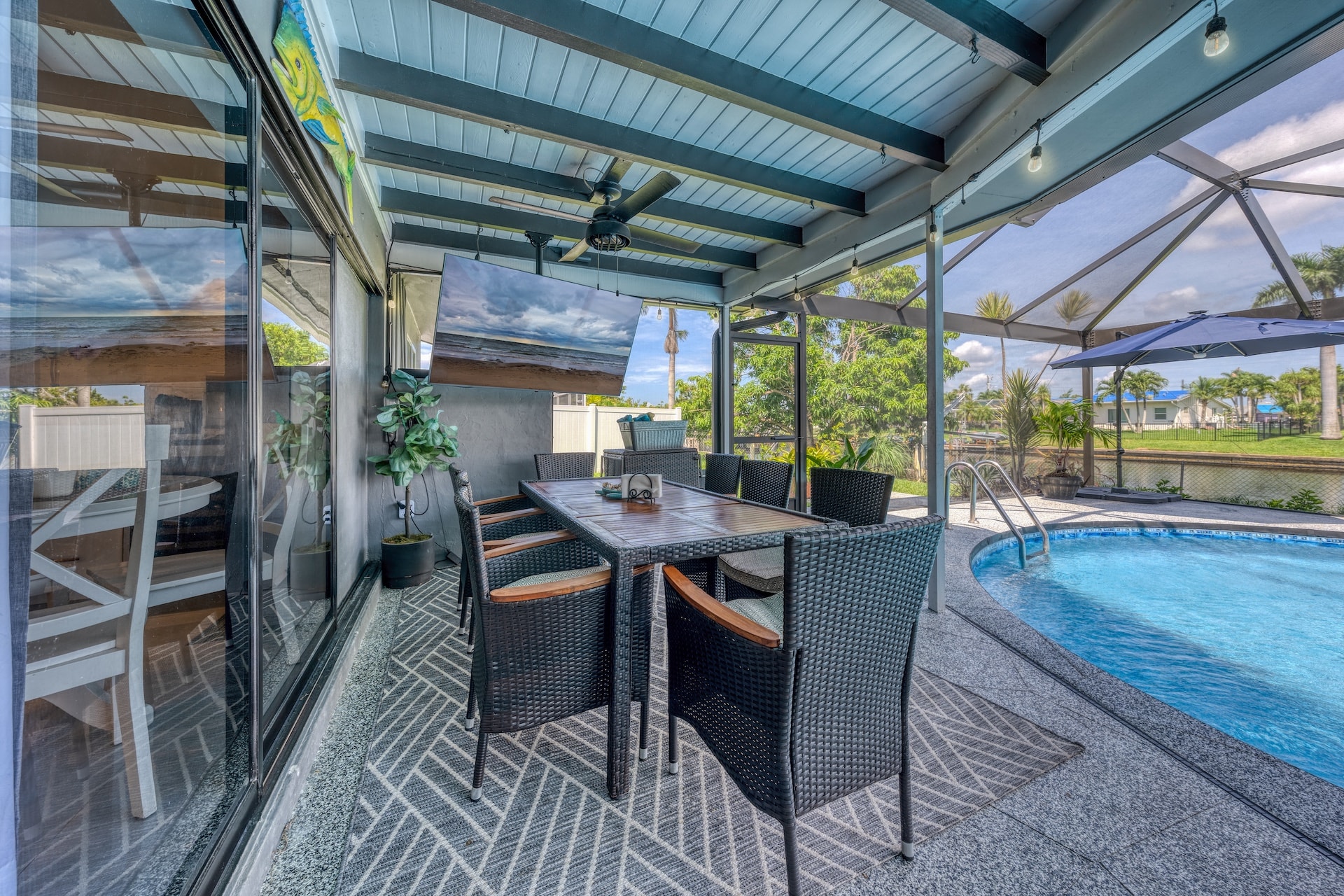 Covered patio dining area with pool view
